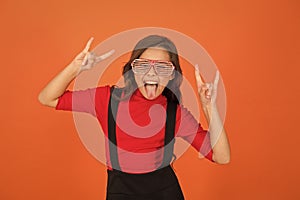 Rock party. Masquerade concept. Kid and striped eyeglasses. Girl with eyeglasses orange background. Event and