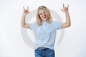 Rock this party up. Portrait of excited and cool good-looking blonde young woman having fun dancing and enjoying photo