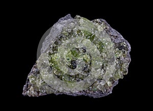 Rock with peridot olivine mineral from the USA isolated on a pure black background photo