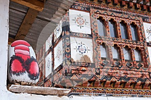 Rock with Phallic image painting on the wall of the house near Chimi Lhakhang monastery,Punakha,Bhutan