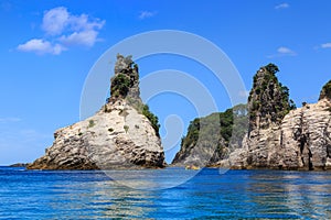 Rock pinnacles jutting out of the ocean, Coromandel Peninsula, New Zealand