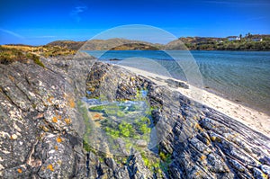 Rock pool Morar coast Scotland UK beautiful coastal Scottish tourist destination in colourful HDR