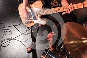 Rock and roll girl playing bass guitar on stage