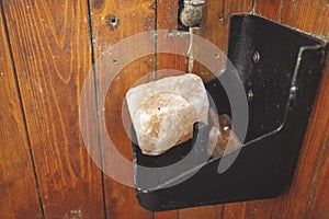 Rock salt for the horse on a shelf inside the horse stable