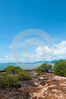 Rock sand beach with green bushes on small island near Koh Lanta