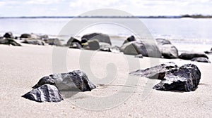 Rock in the sand. Horizon over water, sea scene.