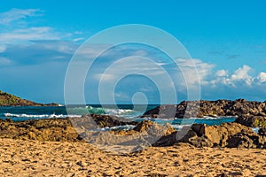 Rock by the sea during the afternoon on the Rio Vermelho beach in Salvador, Brazil photo