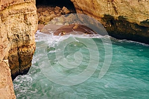 .Rock by the sea. the concept of harmony, energy of life and meditation. benagil in portugal, cliffs on the famous beach , waves c