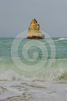 Rock in the sea at Praia do Camilo beach near Lagos, Portugal.