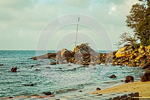 rock in sea shore, pretty calm sea during sunrise in Malaysia