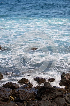 Rock and sea. View of turuoise water and lava rocks beach, atlantic ocean waves. Topical travelling background. Tenerife