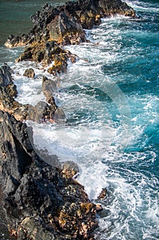 Rock and sea. View of turuoise water and lava rocks beach, atlantic ocean waves. Topical travelling background. Tenerife