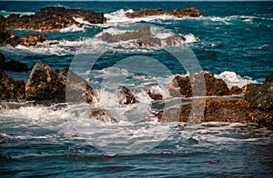 Rock and sea. View of turuoise water and lava rocks beach, atlantic ocean waves. Topical travelling background. Tenerife