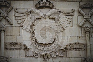 Rock shield, Spanish town of Alcala de Henares, palaces and anci photo