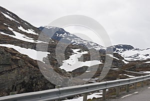 Rock, snow and mountain road