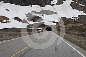 Rock, snow and mountain road, and tunnel