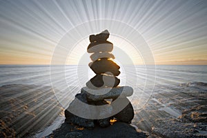 Rock stack with light rays, on the beach at sunset. Big Island, Hawaii