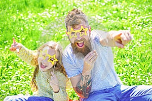 Rock star concept. Family spend leisure outdoors. Child and dad posing with star shaped eyeglases photo booth attribute