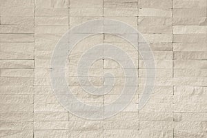 Rock stone tile wall texture rough patterned background in sepia white color