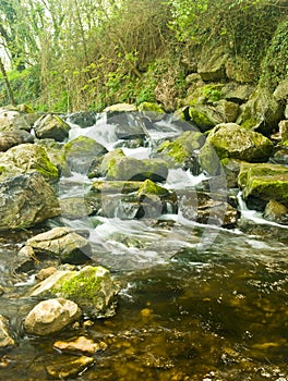 Rock strewn countryside river photo