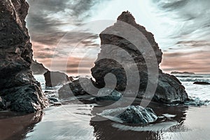 Rock at sunset at a California beach, long exposure