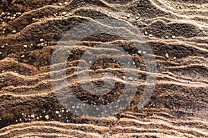 Sandstone rockface layers with pebble stones scattered ideal as natural geologic background