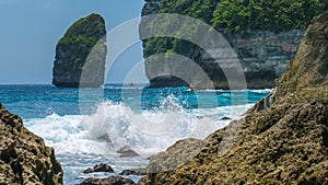 Rock in Tembeling Coastline at Nusa Penida island, Ocean Waves in Front. Bali Indonesia