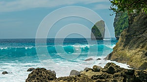 Rock in Tembeling Coastline at Nusa Penida island, Ocean Waves in Front. Bali Indonesia