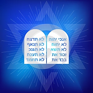 Rock of ten commandments with Hebrew alphabet on blue background