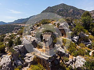 Rock tombs, tombstones and sarcophagi on a mountainside near ancient city of Sura. Turkey