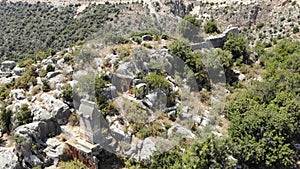 Rock tombs, tombstones and sarcophagi on a mountainside near the ancient city of Sura. Turkey