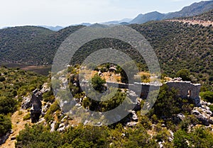 Rock tombs, tombstones and sarcophagi on a mountainside near ancient city of Sura. Turkey