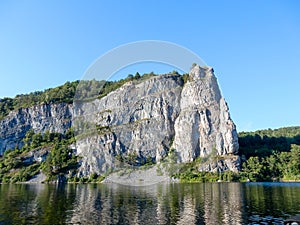 Rock with trees on the water