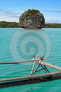 A rock in turquoise water