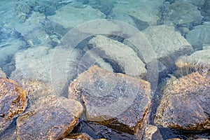 Rock under clear water shore. Pattaya beach, Thailand. South East Asia