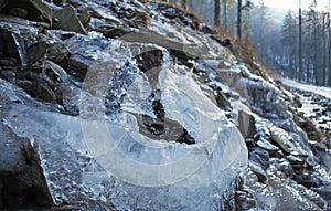 Rock water cascade or frozen waterfall on mountain stream