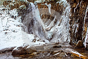 Rock and water cascade in ice