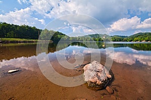 Rock and water reflection at Pocuvadlianske jazero lake in Stiavnicke vrchy
