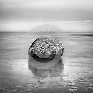 Rock at the waters edge photo