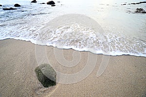Rock and wave on the Ao Sen beach Phuket