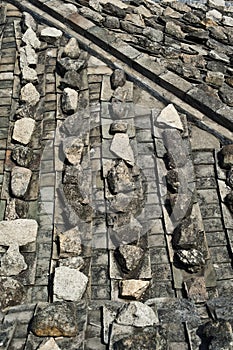 Rock weights on traditional tile roofs
