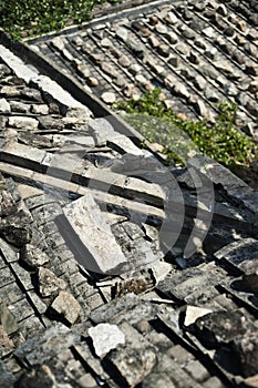 Rock weights on traditional tile roofs