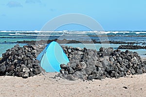 Rock wind shelter on beach at Orzola Lanzarote