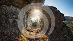 Rock window in mountain with sun