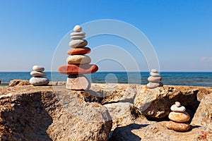 Rock zen pyramid of colorful pebbles on the background of the sea. Concept of balance, harmony and meditation