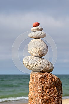 Rock zen pyramid of white pebbles on the background of the sea. Concept of balance, harmony and meditation