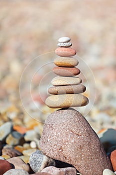 Rock zen pyramid of white, red and yellow stones. Concept of balance, harmony and meditation