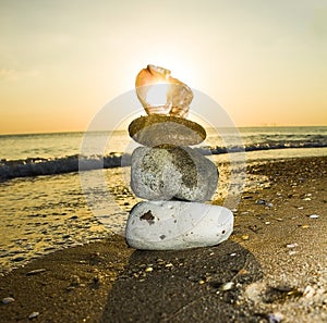 Rock zen pyramid of yellow stones on a background of blue sky and sea. Concept of balance, harmony and meditation