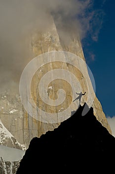 Rockclimber facing the wall of fitz roy peak