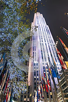 Rockefeller Center by night with international flags and lighting decorations - New York